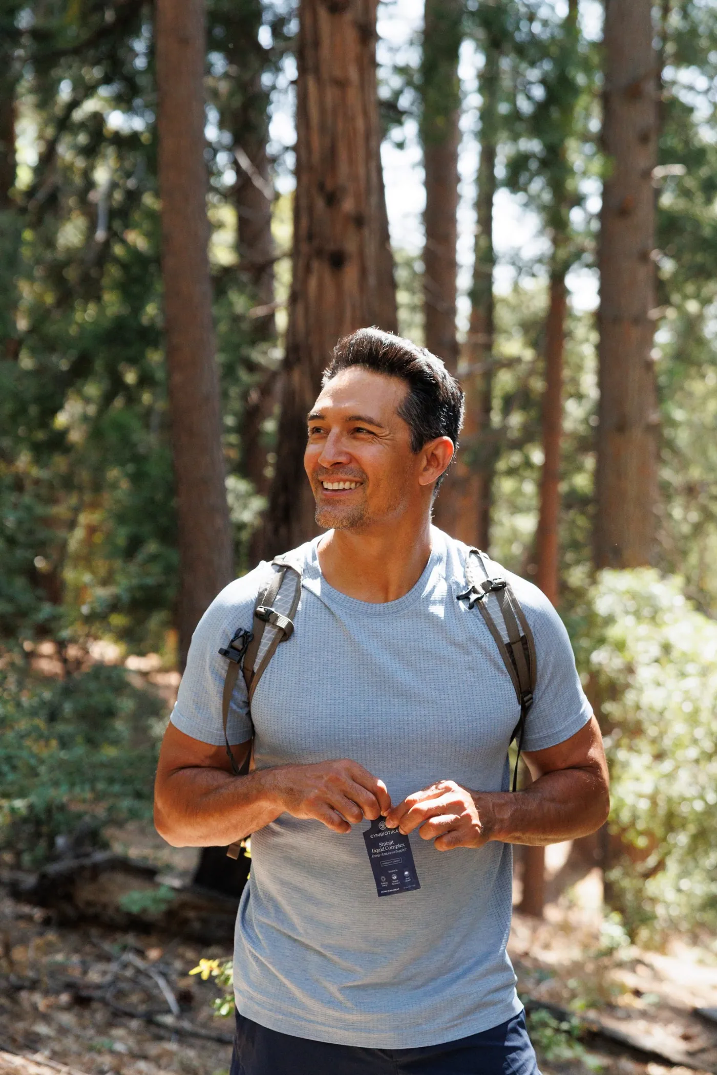 Hiker in the forest with a Shilajit packet