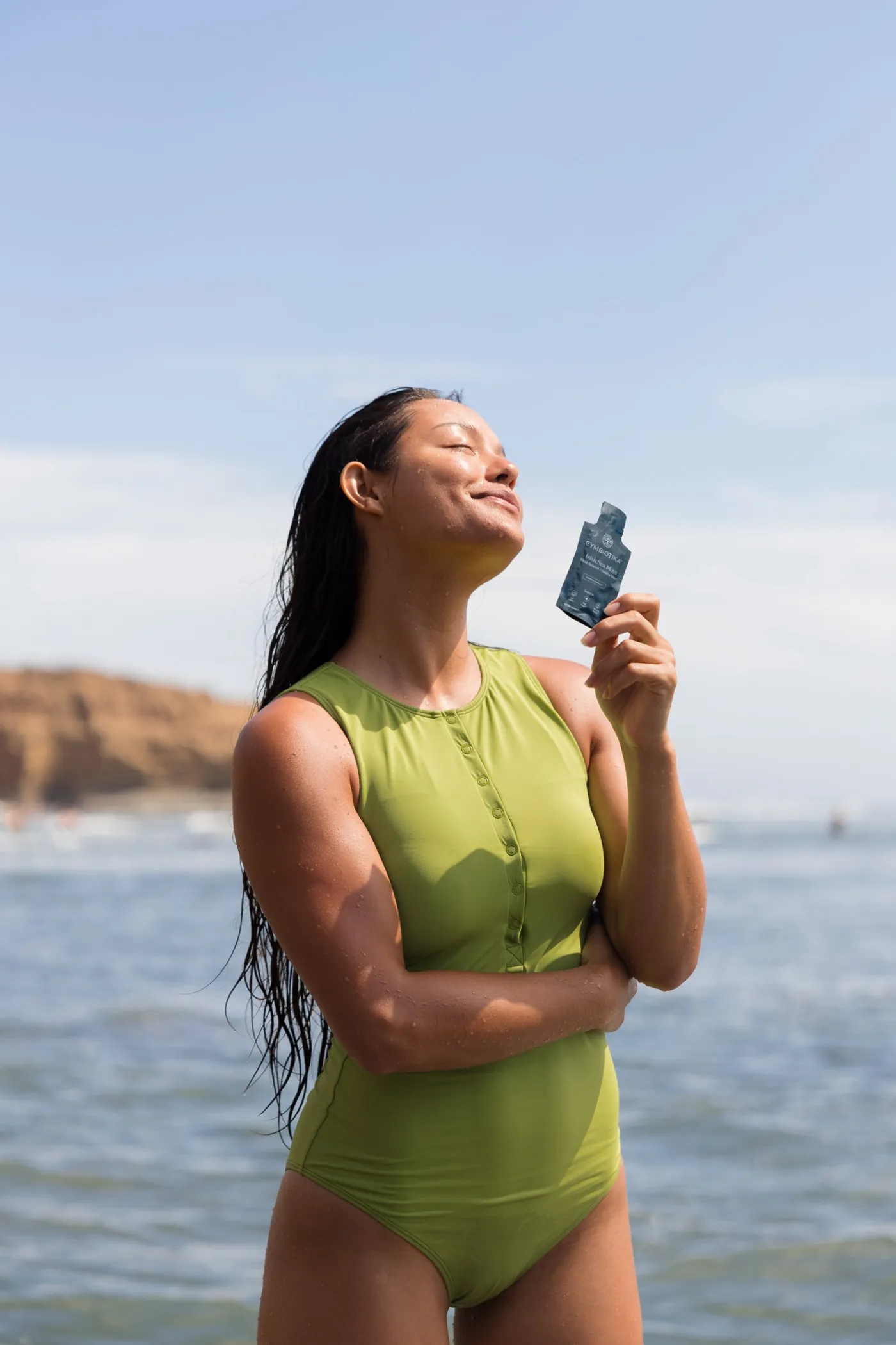 Woman in the ocean holding Irish Sea Moss
